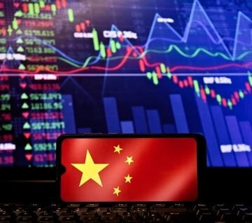 The Chinese national flag overlaid on a smartphone screen against a backdrop of volatile financial data and trading charts.