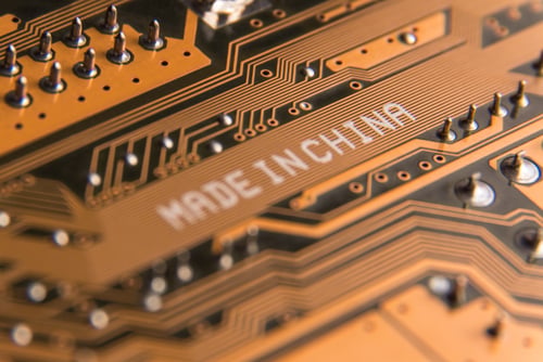Macro,Image,Of,A,Motherboard,With,The,Inscription,"made,In A close-up of a printed circuit board with "MADE IN CHINA" printed on it.