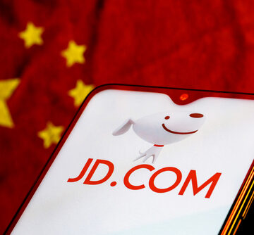 The JD.com logo, a major Chinese e-commerce company, on a smartphone with the flag of China in the background. The JD.com logo, a major Chinese e-commerce company, on a smartphone with the flag of China in the background.