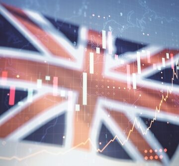 Multi,Exposure,Of,Virtual,Creative,Financial,Graph,And,World,Map British flag background with digital overlays of financial charts, forex trading data, and business graphs.