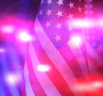 Police,Red,And,Blue,Lights,,Double,Exposure,With,Flag,Of AMERICA THE UNFREE—HOME OF THE POLICED, SURVEILLED AND OCCUPIED