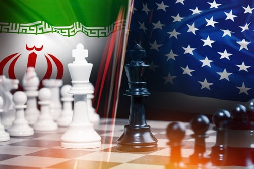 An overlay of a chess game, with kings prominently positioned, against the Iranian and U.S. flags. An overlay of a chess game, with kings prominently positioned, against the Iranian and U.S. flags.