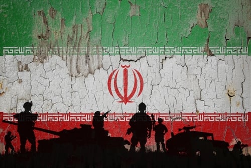 Iran,Flag,Painted,On,The,Cracked,Wall,And,Soldiers,Shadow. IRAN EMERGES FROM WAR WITH NEW POWER