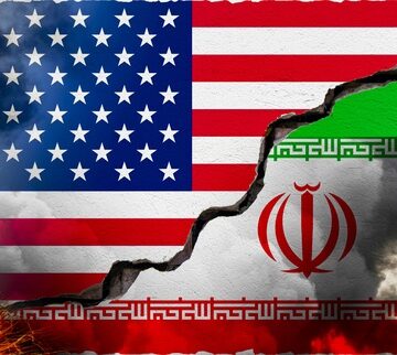 The flags of the U.S. and Iran separated by a large crack. The flags of the U.S. and Iran separated by a large crack.