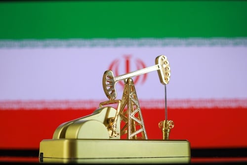 A miniature golden oil pump against the backdrop of the Iranian flag. A miniature golden oil pump against the backdrop of the Iranian flag.