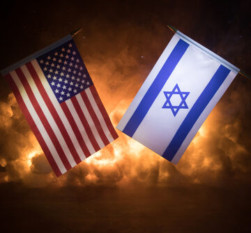 The flags of the USA and Israel against a background of dark smoke and flames.