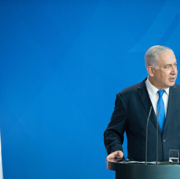 Benjamin Netanyahu, the Prime Minister of Israel, speaking from a podium. Benjamin Netanyahu, the Prime Minister of Israel, speaking from a podium.