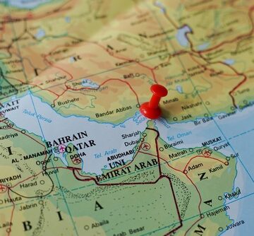 Red,Pushpin,Marking,The,Strait,Of,Hormuz,On,World,Map A red pushpin on the map marks the Strait of Hormuz, a strategically vital waterway connecting the Persian Gulf to the Gulf of Oman and the Arabian Sea.