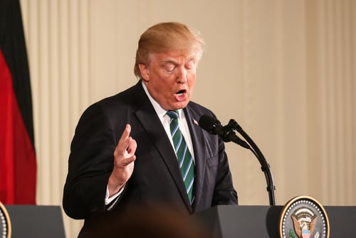 Donald Trump speaking at a podium in Washington, DC. Donald Trump speaking at a podium in Washington, DC.