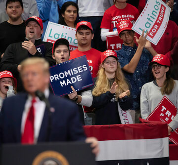 Charlotte,,North,Carolina,-,2,March,2020:,President,Trump's,Young Donald Trump speaking at a campaign rally in Charlotte, North Carolina, flanked by supporters holding signs.