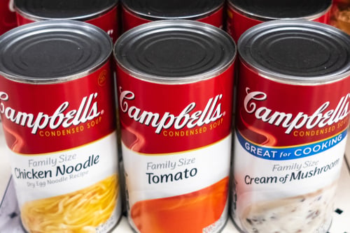 A lineup of Campbell soup cans including Chicken Noodle, Tomato, and Cream of Mushroom featuring easy-open pop tops and non-BPA lining in some versions. A lineup of Campbell soup cans including Chicken Noodle, Tomato, and Cream of Mushroom featuring easy-open pop tops and non-BPA lining in some versions.