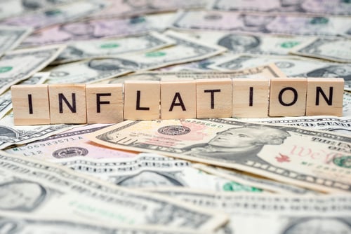 A row of scrabble pieces spelling the word "Inflation" sitting atop a mass of U.S. currency. A row of scrabble pieces spelling the word "Inflation" sitting atop a mass of U.S. currency.