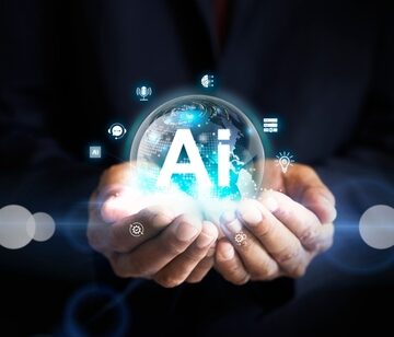 Human hands holding an AI icon in the form of a glowing globe. Human hands holding an AI icon in the form of a glowing globe.