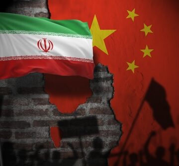 Concept illustration juxtaposes the national flags of Iran and the People's Republic of China over a crumbling brick wall backdrop depicting silhouetted protesters and flags. Concept illustration juxtaposes the national flags of Iran and the People's Republic of China over a crumbling brick wall backdrop depicting silhouetted protesters and flags.