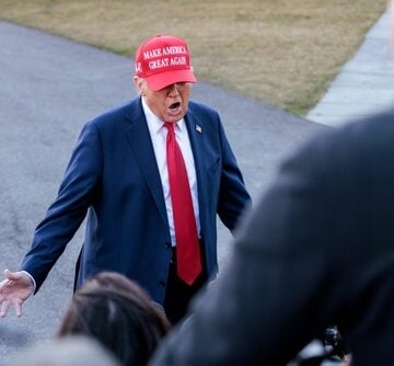 President Donald Trump wearing a red "Make America Great Again" hat and a blue suit while speaking to reporters on the South Lawn of the White House in February 2025. President Donald Trump wearing a red "Make America Great Again" hat and a blue suit while speaking to reporters on the South Lawn of the White House in February 2025.