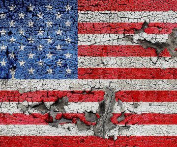 A tattered-looking American flag painted on a cracked, peeling surface. A tattered-looking American flag painted on a cracked, peeling surface.