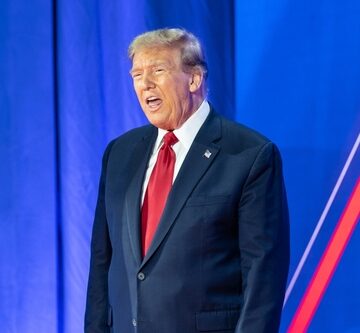 Donald Trump on stage delivering remarks at CPAC.