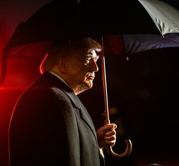 Donald Trump, holding a large black umbrella on the South Lawn of the White House, before boarding Marine One. Donald Trump, holding a large black umbrella on the South Lawn of the White House, before boarding Marine One.