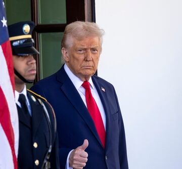 Donald Trump gives a thumbs-up at the entrance to the White House. Donald Trump gives a thumbs-up at the entrance to the White House.