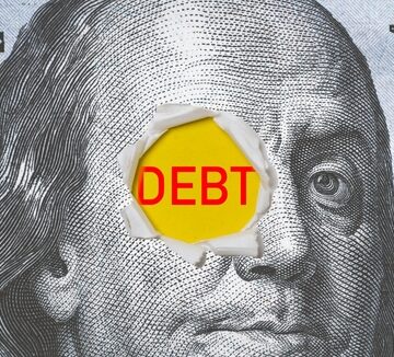 The face of Benjamin Franklin on a $100 bill torn open to reveal the word "DEBT". The face of Benjamin Franklin on a $100 bill torn open to reveal the word "DEBT".