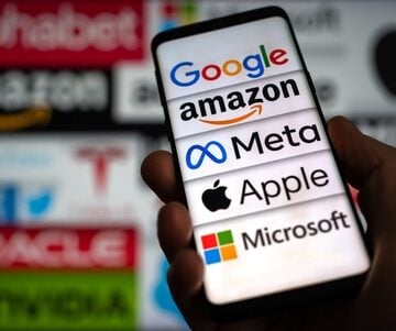 The corporate logos of five prominent American technology giants – Google (Alphabet), Amazon, Meta, Apple, and Microsoft – seen on a mobile phone screen.