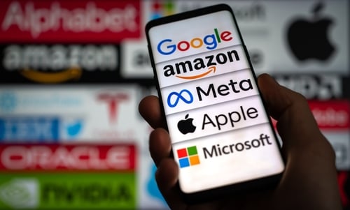 The corporate logos of five prominent American technology giants – Google (Alphabet), Amazon, Meta, Apple, and Microsoft – seen on a mobile phone screen.