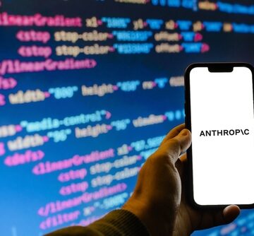 A smartphone with the Anthropic logo superimposed against a background of SVG/HTML code. A smartphone with the Anthropic logo superimposed against a background of SVG/HTML code.
