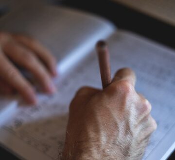 A person engaged in writing, often representing activities like studying, journaling, or working on documents. A person engaged in writing, often representing activities like studying, journaling, or working on documents.