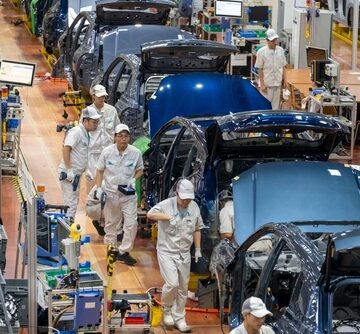 Workers assembling electric vehicles on a modern production line at the GAC Aion Intelligent Ecological Factory located in Guangzhou, Guangdong, China. Workers assembling electric vehicles on a modern production line at the GAC Aion Intelligent Ecological Factory located in Guangzhou, Guangdong, China.