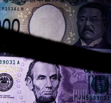 A close-up comparison of a Japanese Yen note featuring the rising sun and a U.S. dollar displaying Abraham Lincoln. A close-up comparison of a Japanese Yen note featuring the rising sun and a U.S. dollar displaying Abraham Lincoln.