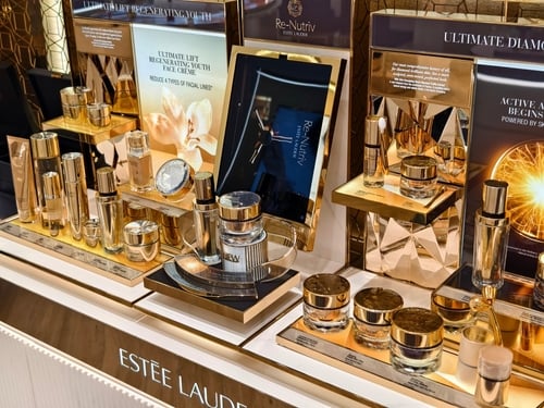 A luxury retail display counter showcasing skincare products from the Estée Lauder Re-Nutriv collection. A luxury retail display counter showcasing skincare products from the Estée Lauder Re-Nutriv collection.