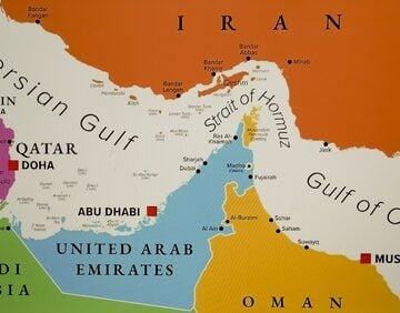 Close-up view of a map featuring the Strait of Hormuz, a vital 33-kilometer-wide maritime chokepoint located between Iran to the north and Oman/UAE to the south.