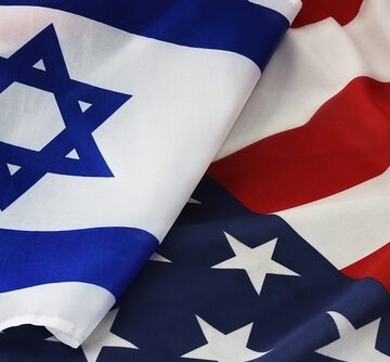 The national flag of Israel draped alongside the national flag of the U.S., symbolizing their long-standing strategic alliance.