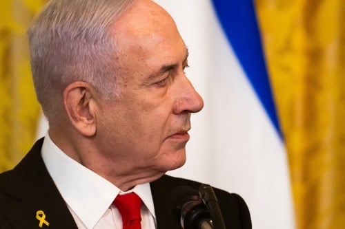 Prime Minister Benjamin Netanyahu wearing a yellow ribbon lapel pin, a symbol used to call for the return of hostages held in Gaza. Prime Minister Benjamin Netanyahu wearing a yellow ribbon lapel pin, a symbol used to call for the return of hostages held in Gaza.