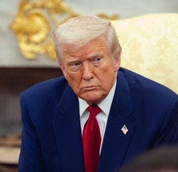 An unsmiling Donald Trump sitting in the Oval Office. An unsmiling Donald Trump sitting in the Oval Office.