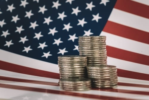 Stacks of U.S. coins in front of an American Flag. Stacks of U.S. coins in front of an American Flag.
