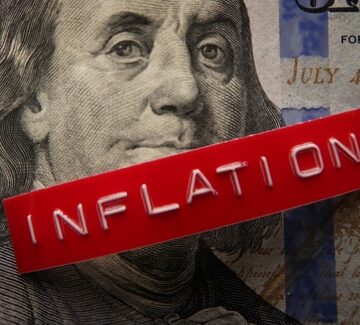 Concept image representing economic impact of inflation using an American hundred-dollar bill overlaid with a red embossed label that reads "INFLATION". Concept image representing economic impact of inflation using an American hundred-dollar bill overlaid with a red embossed label that reads "INFLATION".