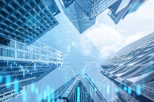 Image features modern skyscrapers from a low-angle perspective overlaid with a blue digital financial chart. Image features modern skyscrapers from a low-angle perspective overlaid with a blue digital financial chart.