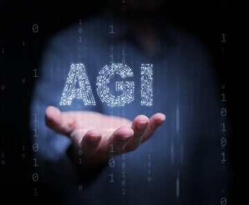 Conceptual photo representing Artificial General Intelligence (AGI), showing a person's hand with a glowing digital "AGI" text overlay amidst binary code. Conceptual photo representing Artificial General Intelligence (AGI), showing a person's hand with a glowing digital "AGI" text overlay amidst binary code.