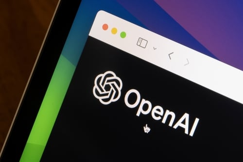 An image of the OpenAI logo displayed on a mobile phone screen. An image of the OpenAI logo displayed on a mobile phone screen.