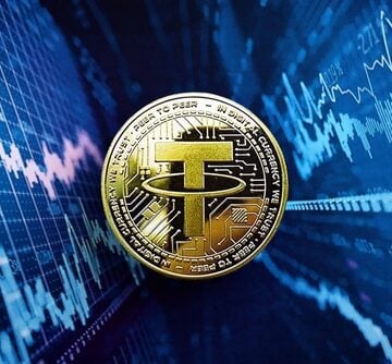 A physical representation of the Tether (USDT) cryptocurrency coin against a blue digital trading background. A physical representation of the Tether (USDT) cryptocurrency coin against a blue digital trading background.