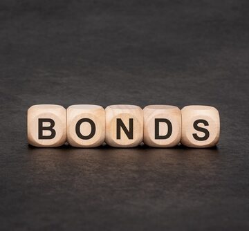 Five wooden dice spelling the word "BONDS". Five wooden dice spelling the word "BONDS".