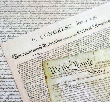 Closeup of the Declaration of Independence and the U.S. Constitution, two of the foundational texts of the United States. Closeup of the Declaration of Independence and the U.S. Constitution, two of the foundational texts of the United States.