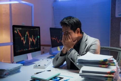 Stressed,Asian,Businessman,Covering,His,Face,With,Hands,While,Sitting THE PRESSURE IS BUILDING ACROSS THE ENTIRE SYSTEM…