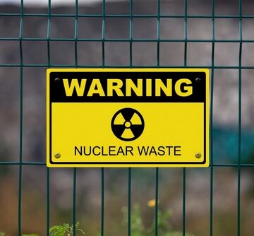 Black,And,Yellow,Warning,Sign,On,A,Fence,Displaying,A WHY NUCLEAR WASTE ISN’T REALLY WASTE