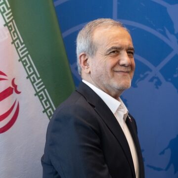 Iranian President Masoud Pezeshkian standing in front of an Iranian flag and a United Nations backdrop. Iranian President Masoud Pezeshkian standing in front of an Iranian flag and a United Nations backdrop.