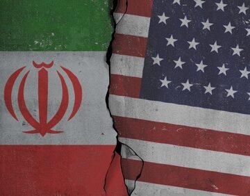 The flags of Iran and the United States separated by a jagged crack. The flags of Iran and the United States separated by a jagged crack.