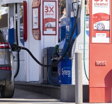 The photo shows a vehicle refueling at a Mobil gas station.