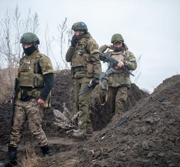 Image shows Ukrainian soldiers approaching a trench on the outskirts of Kyiv, Ukraine, in April 2022. Image shows Ukrainian soldiers approaching a trench on the outskirts of Kyiv, Ukraine, in April 2022.