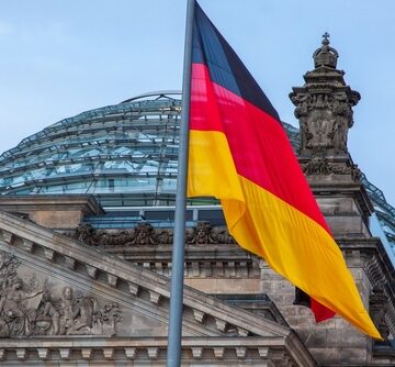 Reichstag,Building,In,Berlin,,Germany,,With,The,German,Flag,Flying. GERMANY ON THE MARCH… MILITARY BUILDUP IS BEING NOTICED BY NEIGHBORS, REPORT SAYS